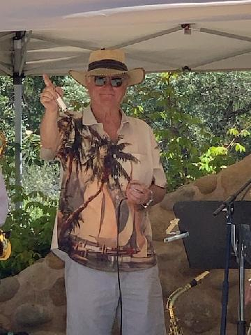 Female drummer with saxophone in background