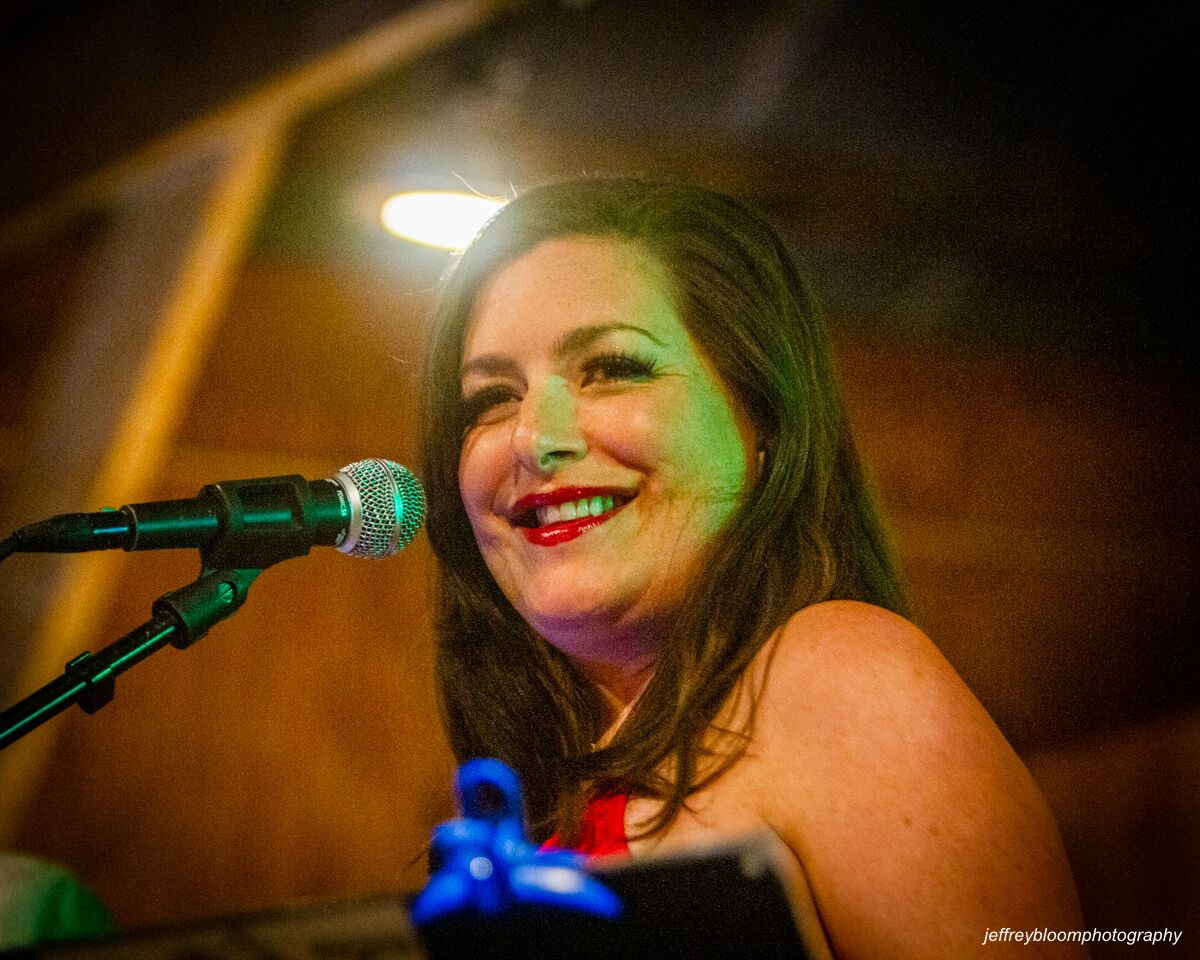 Baritone saxophone player in white jacket